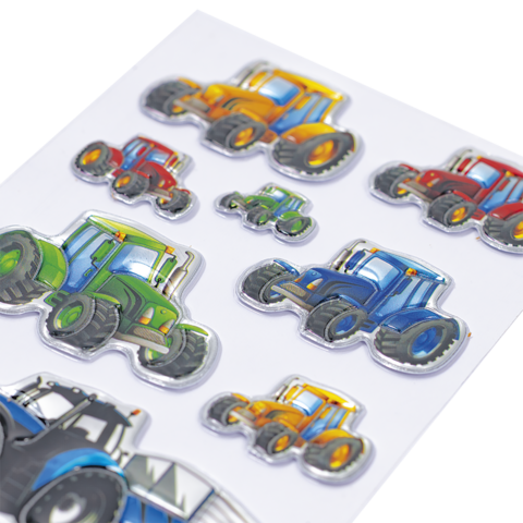 Bunte Aufkleber von Traktoren in verschiedenen Größen und Farben, darunter grüne, rote, blaue und gelbe Modelle.