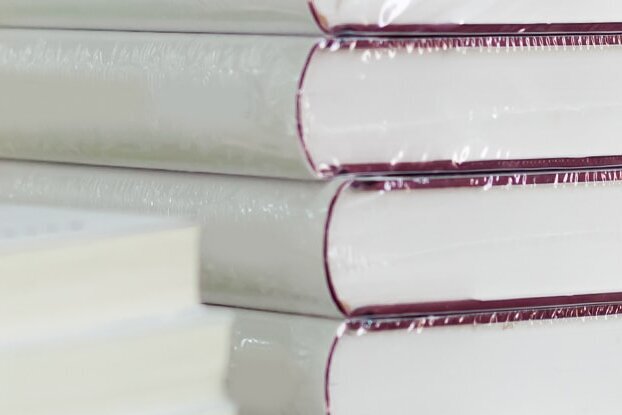 In folie ingepakte boeken, als stapel, beeldmotief voor boeketikettering met afneembare etiketten van HERMA, liggend formaat.