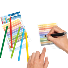 Bunte Stifte liegen neben einem Blatt, auf dem mit einem Stift geschrieben wird. Farbkarten sind ebenfalls sichtbar.